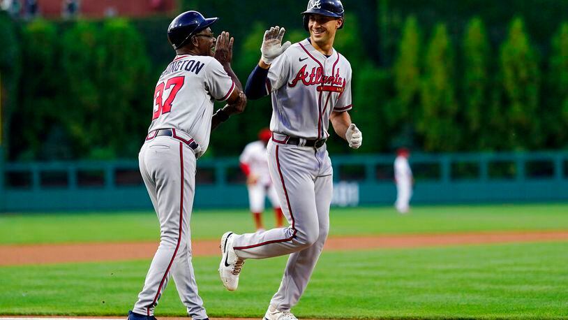 Matt Olson of the Braves, right, celebrates with third base coach Ron Washington after hitting a home run against Philadelphia Phillies pitcher Zack Wheeler during the first inning, Tuesday, June 28, 2022, in Philadelphia. (AP Photo/Matt Slocum)