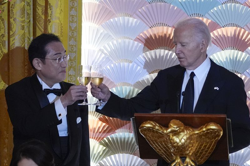 President Joe Biden makes a toast with Japanese Prime Minister Fumio Kishida during a State Dinner at the White House, Wednesday, April 10, 2024, in Washington. (AP Photo/Evan Vucci)