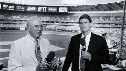 Ernie Johnson Sr. (left) stand with Dale Murphy in the broadcast booth on June 30, 1993. AJC file photo