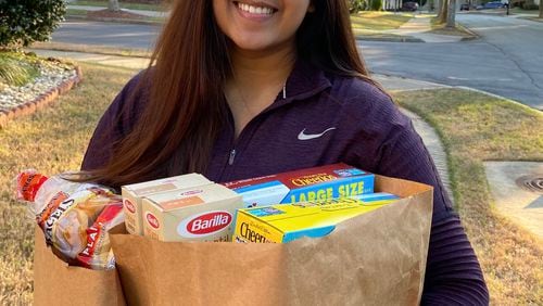 Hiral Patel, a second-year medical student at PCOM Georgia, delivers groceries to seniors and medically fragile individuals as part of a volunteer program she and other medical students began to help the community. (Courtesy COVID Captains)