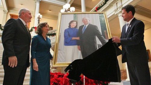 Brian Kemp and Sonny Perdue, shown with his wife Mary, go back a long way as political allies. In 2010, the Perdues watched as their official portrait was unveiled by then-Secretary of State Brian Kemp. (John Spink / AJC file photo)