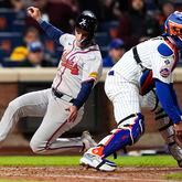Atlanta Braves' Zack Short, left, scores after Marcell Ozuna (not shown) singled on a ground ball during the eighth inning of a baseball game against the New York Mets, Sunday, May 12, 2024, in New York. (AP Photo/Julia Nikhinson)