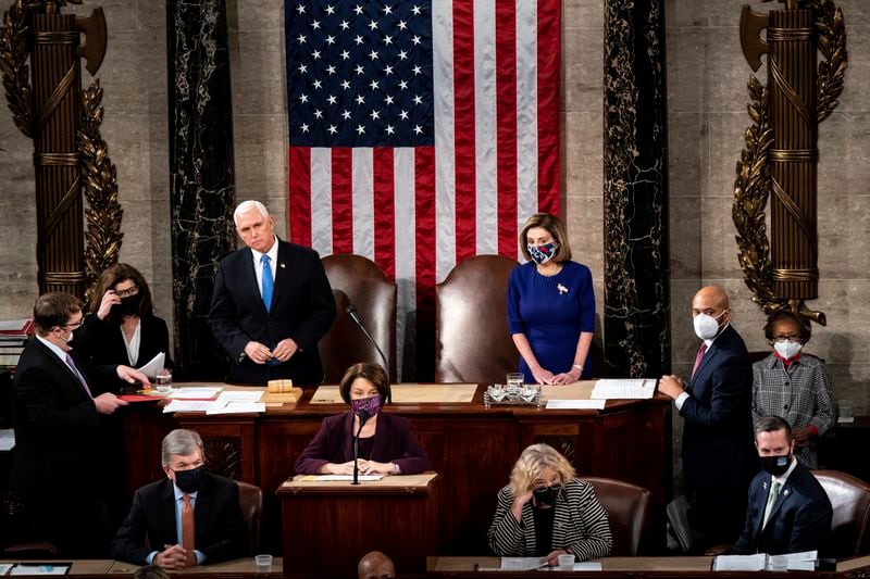 Vice President Mike Pence and House Speaker Nancy Pelosi (D-Calif.) preside over a joint session of Congress convened to certify the Electoral College votes in November's election, at the Capitol in Washington, Wednesday, Jan. 6, 2021. A mob of people loyal to President Trump stormed the Capitol following a rally, halting Congresss counting of the electoral votes to confirm President-elect Joe Bidens victory as the police evacuated lawmakers from the building in a scene of violence, chaos and disruption that shook the core of American democracy. (Erin Schaff/The New York Times)