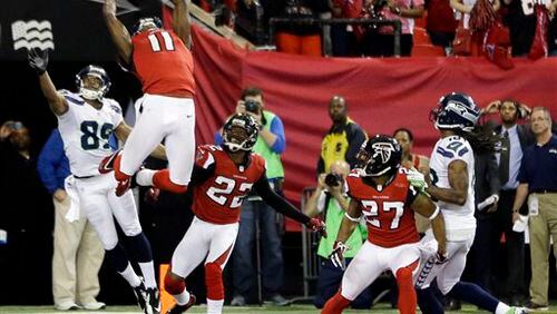 Atlanta Falcons' Julio Jones (11) intercepts a pass on a Seattle Seahawks quarterback Russell Wilson Hail-Mary pass during the second half of an NFC divisional playoff NFL football game Sunday, Jan. 13, 2013, in Atlanta. The Falcons won 30-28. (AP Photo/David Goldman)