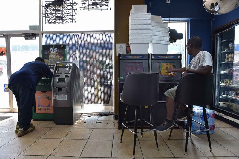 A customer plays a coin operated amusement machine inside a convenience store in the Pittsburgh neighborhood. An ongoing case accuses Lottery officials of showing favoritism in enforcement to large game owners with politically connected lawyers. HYOSUB SHIN / HSHIN@AJC.COM