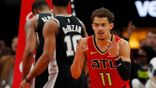 Trae Young of the Atlanta Hawks reacts after a basket against the San Antonio Spurs in the second half at State Farm Arena on March 06, 2019 in Atlanta, Georgia.