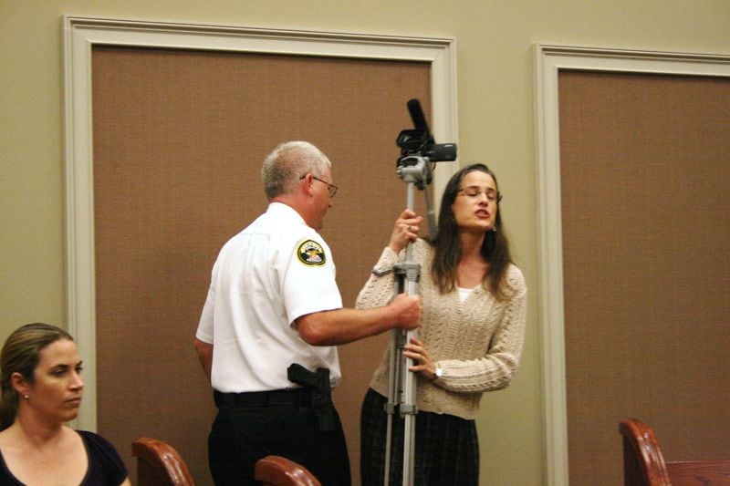 Cumming Police Chief Casey Tatum takes control of a camera operated by Nydia Tisdale during an April 17, 2012 Cumming City Council meeting. Credit: Aldo Nahed/Forsyth Herald