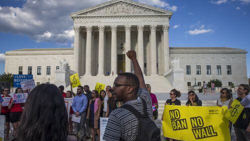 Protesters gather outside the Supreme Court after it announced that it would hear arguments on President Donald Trump’s revised travel ban, in Washington, June 26, 2017. The Supreme Court on Monday canceled oral arguments in the case, citing the new travel restrictions he issued Sunday. (Al Drago/The New York Times)