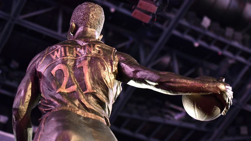 The Hawks unveiled a large statue of legendary Hawks player Dominique Wilkins during a private luncheon and ceremony at Philips Arena on Thursday, March 5, 2015. Measuring 13½ feet in height, the granite statue was unveiled at a private luncheon and ceremony on the arena floor. HYOSUB SHIN / HSHIN@AJC.COM