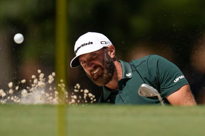 Dustin Johnson hits from the bunker on the seventh hole during second round at the Masters golf tournament at Augusta National Golf Club Friday, April 12, 2024, in Augusta, Ga. (AP Photo/Ashley Landis)