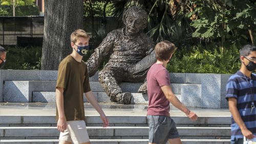 Georgia Tech students masked up and enjoyed a warm day alongside the Albert Einstein monument (who was not wearing a mask) on the Georgia Tech campus on Monday, August 10, 2020. The Albert Einstein Monument on at the northwest corner of Tech Green near the Atlantic Promenade is a 3,500 pound statue that was created by American sculptor Robert Berks (1922-2011). JOHN SPINK/JSPINK@AJC.COM