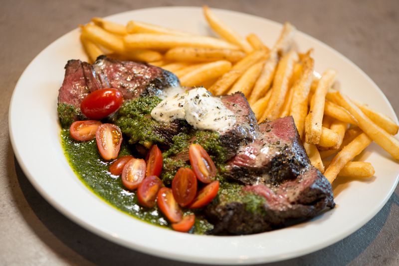  Steak Frites with french fries, compound butter, and bacon chimichurri sauce. Photo credit- Mia Yakel.