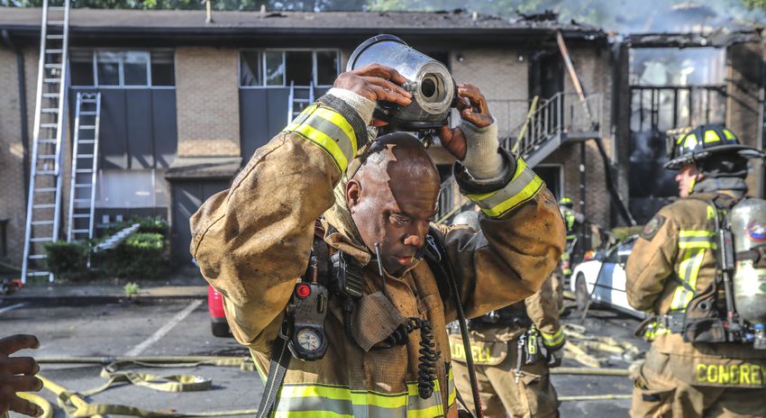 July 7, 2022 Atlanta: Atlanta firefighters had a hot morning battling an apartment blaze in the 2200 block of Campbellton Road in Atlanta on Thursday, July 7, 2022. The call came in at 9 am for the Adams House Apartments where units arrived to heavy smoke conditions according to Atlanta Fire Rescue Captain Taurus Durrah. Flames erupted from the bottom floor to the top floor and then the attic Durrah said. Crews initially had to bring in tank water to get water on the fire because of the 800 foot distance to the hydrant on Campbellton Road. Four units were damaged and 8-families displaced. No one was injured and the fire is under investigation. Durrah said more units are being sent to fire scene to shorten the rotation of fire crews due to the heat. Firefighters are told to hydrate  and stay cool a full shift before coming to work to combat the heat. (John Spink / John.Spink@ajc.com)


