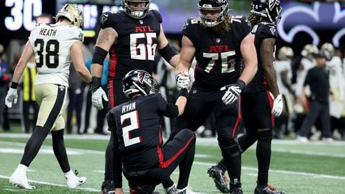 Jan. 9, 2022 - Atlanta, Ga: Atlanta Falcons quarterback Matt Ryan (2) is helped up by offensive tackle Kaleb McGary (76) as guard Colby Gossett (66) is shown during the second half against the New Orleans Saints at Mercedes-Benz Stadium, Sunday, January 9, 2022, in Atlanta. JASON GETZ FOR THE ATLANTA JOURNAL-CONSTITUTION



