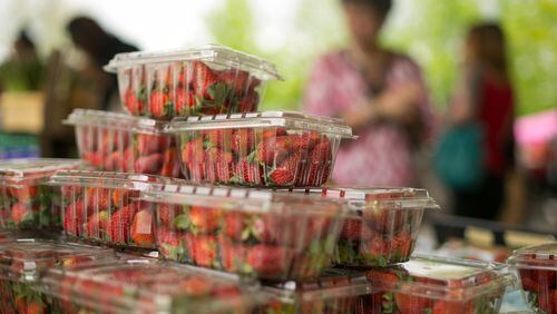 Organic strawberries from Watsonia Farms, of Monetta, South Carolina, are shown for purchase during the Johns Creek farmers market at the Newtown Park Amphitheater in April 2015.