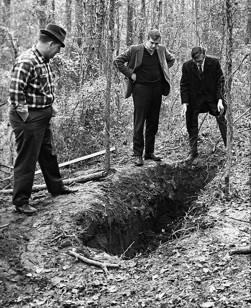 Newsmen and onlookers inspect the hole in which Barbara Jane Mackle was buried. The Emory University student, daughter of Miami millionaire Robert Mackle, was found after her father paid a half-million-dollar ransom. She was unearthed after 83 hours, physically unharmed.