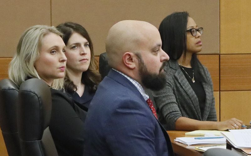 Jenna Garland (second from left) sits with her attorneys as the prosecution delivers their opening statement. The trial began Tuesday in the first-ever criminal prosecution of an alleged violation of the Georgia Open Records Act. BOB ANDRES / BANDRES@AJC.COM