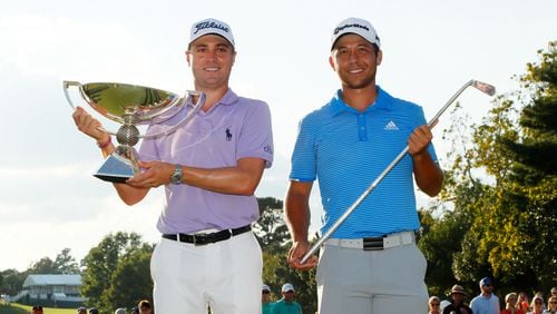 It's a slightly awkward end to the 2017 Tour Championship when Justin Thomas, left, and Xander Schauffele share the stage with two different trophies. (Kevin C. Cox/Getty Images)