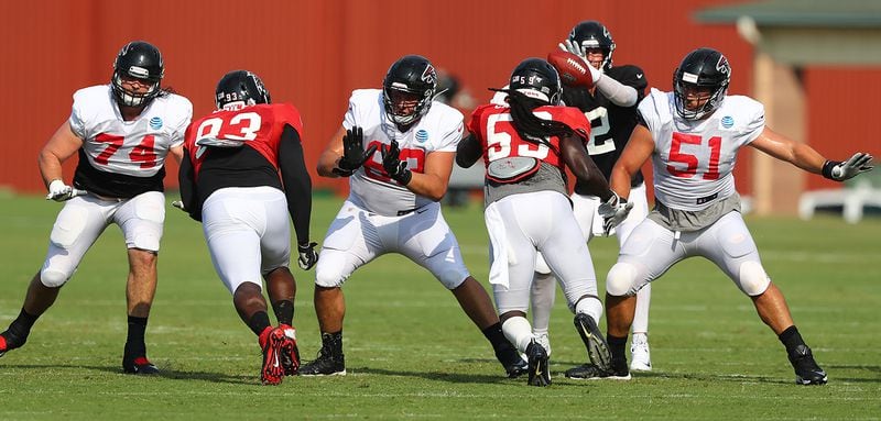 Falcons offensive lineman Ty Sambrailo (from left), Chris Lindstrom, and Alex Mack block for Matt Ryan during team practice Monday, July 29, 2019, in Flowery Branch.