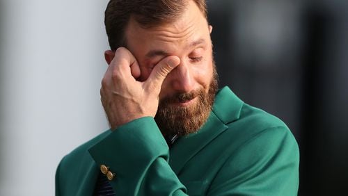 Dustin Johnson shows his emotions after Tiger Woods presented him the green jacket for winning last November's Masters. (Curtis Compton/Atlanta Journal-Constitution/TNS)
