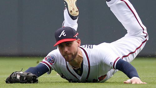 Braves centerfielder Ender Inciarte makes a diving catch on a ball hit by the Mets' Kevin Plawecki Sunday. Inciarte has been playing with a wrap on his left hand due to left-thumb soreness. (AP Photo/Tami Chappell)