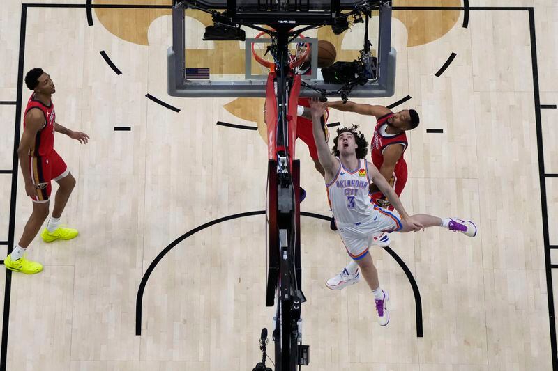 Oklahoma City Thunder guard Josh Giddey (3) goes to the basket against New Orleans Pelicans guard CJ McCollum (3) in the first half of Game 3 of an NBA basketball first-round playoff series in New Orleans, Saturday, April 27, 2024. (AP Photo/Gerald Herbert)