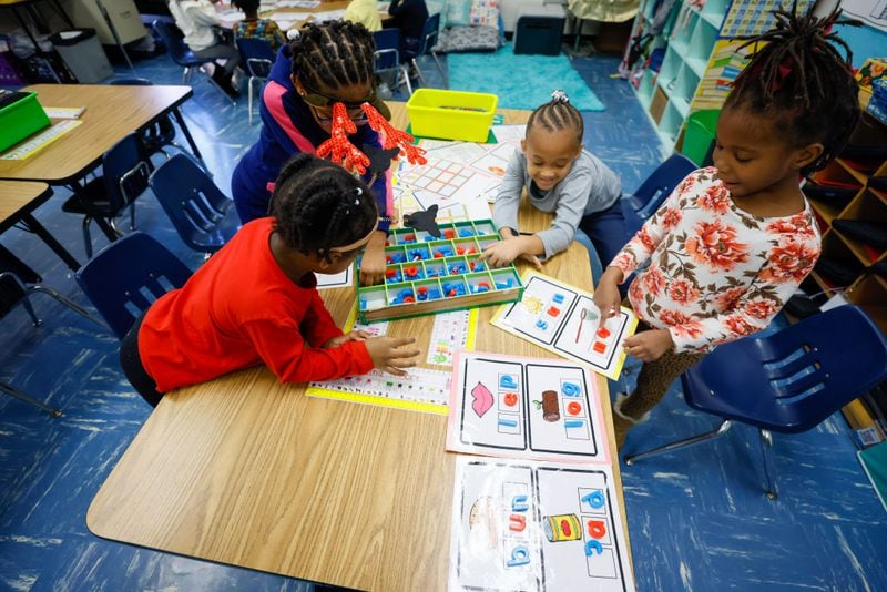 Instead of using Chromebooks, kindergarten students at Austin Rd Elementary School are seen using old-school boards and letters to work on a spelling activity. Miguel Martinez /miguel.martinezjimenez@ajc.com