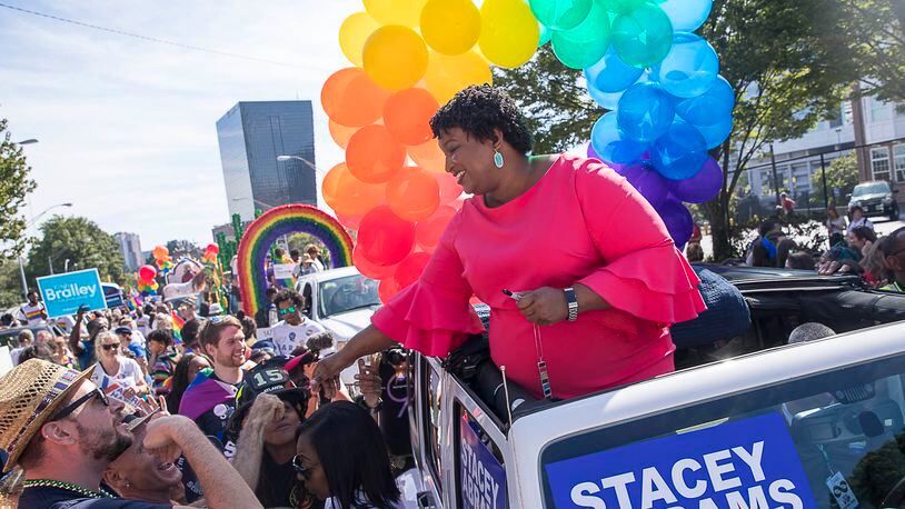 Gubernatorial candidate Stacey Abrams greets supporters at the Atlanta Pride Parade. Abrams made history by being the first ever Georgia gubernatorial candidate to ride along in the parade.