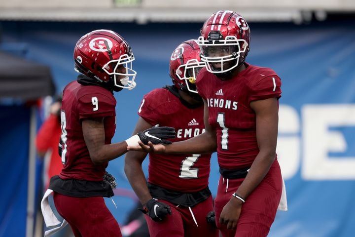 Warner Robins quarterback Jalen Addie (1) celebrates a rushing touchdown with wide receiver Armon Porter, left, in the first half against Cartersville during the first half of their Class 5A state high school football final at Center Parc Stadium Wednesday, December 30, 2020 in Atlanta. JASON GETZ FOR THE ATLANTA JOURNAL-CONSTITUTION