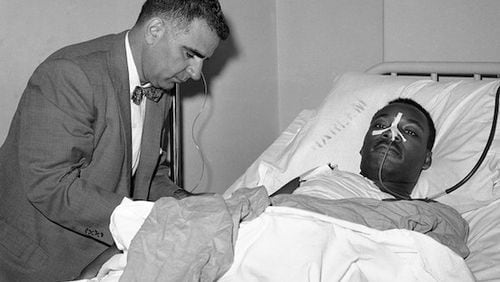 Dr. Emil A. Naclerio, member of the surgical team that operated on the Rev. Martin Luther King, at King’s bedside in Harlem Hospital in New York on Sept. 21, 1958. Rev. King, stabbed by Izola Ware Curry as he appeared at a Harlem Department store on September 20, was still on the critical list after an operation.