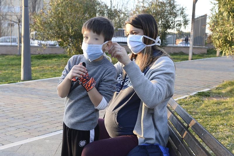 Mother and son wearing a protective face mask against the coronavirus at the park in Rome, Italy (Photo by Silvia Loré/Sipa USA)(Sipa via AP Images)