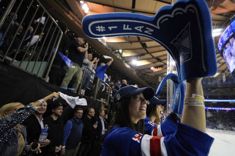 New York Rangers fans cheer during the second period in Game 2 of the team's NHL hockey Stanley Cup second-round playoff series against the Carolina Hurricanes, Tuesday, May 7, 2024, in New York. (AP Photo/Julia Nikhinson)