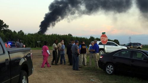 Emergency officials respond to the site of a military plane crash near Itta Bena, Miss., on Monday, July 10, 2017. (Elijah Baylis/The Clarion-Ledger via AP)