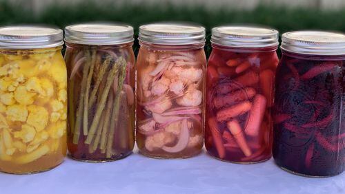 There’s more than one combination for pickling vegetables. Here are some options: (from left) cauliflower with saffron and coriander seeds; asparagus with red onion and brown mustard seeds; cauliflower with red onion and black peppercorns; tricolored baby carrots with fresh dill; and beets with white onion and ginger. CONTRIBUTED BY KELLIE HYNES