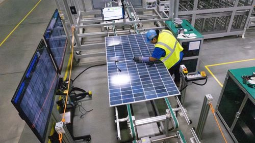A worker at Qcells new manufacturing factory in Cartersville conducted quality performance checks on a freshly assembled solar panel on Tuesday, April 2, 2024.