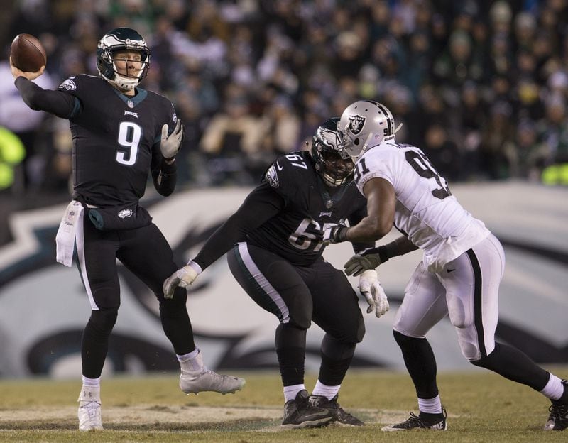 Nick Foles of the Philadelphia Eagles passes the ball as Chance Warmack blocks Shilique Calhoun  of the Oakland Raiders in the second quarter at Lincoln Financial Field on December 25, 2017 in Philadelphia, Pennsylvania. (Photo by Mitchell Leff/Getty Images)