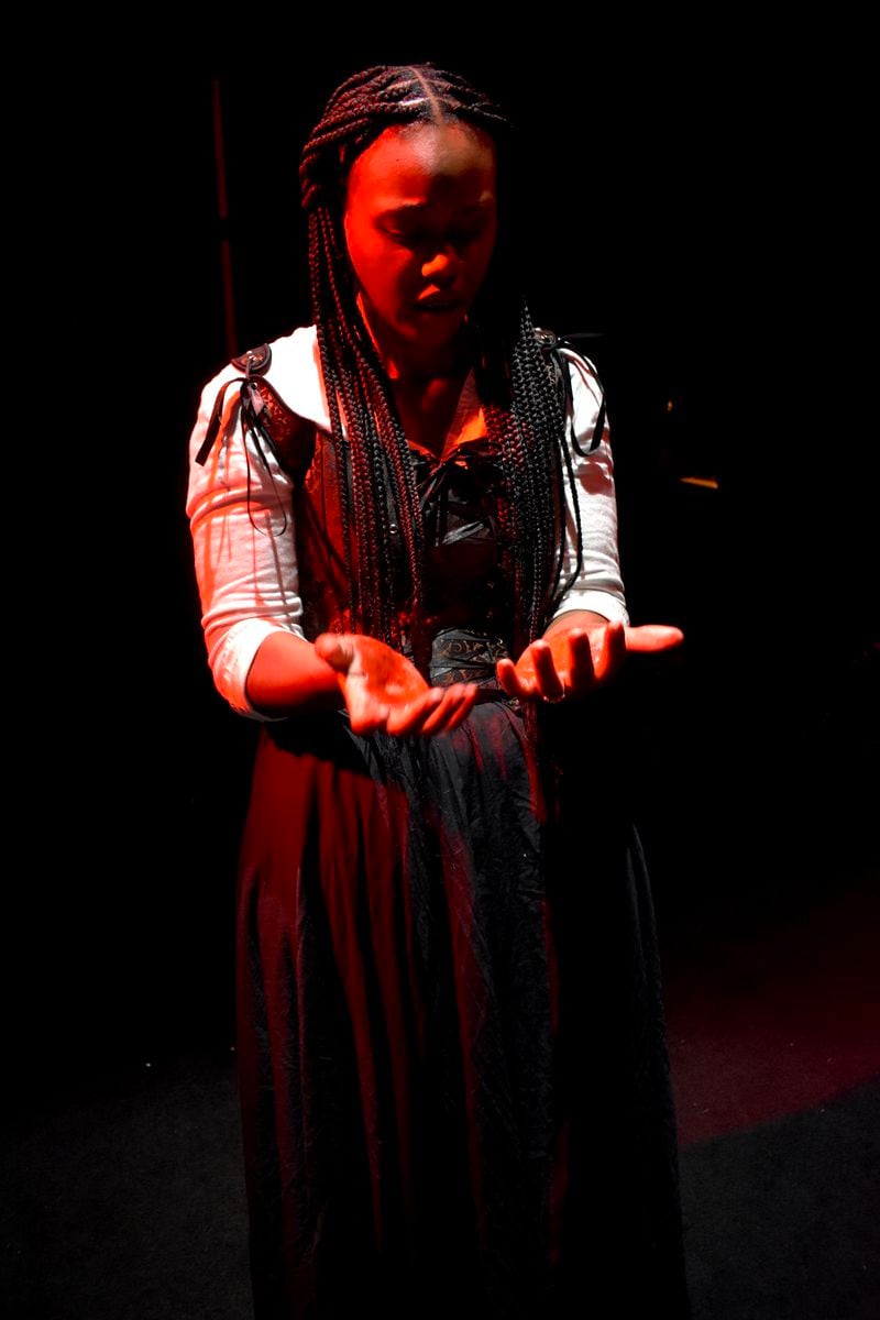 Al’Rasyah Fairley examines her bloodied hands as Lady Macbeth.