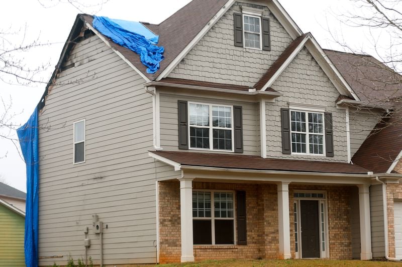 In December, a tarp covered part of Tawana Randall's fire-gutted house in Conyers. But after her August fire, it was listed for rent on Progress' website, a screenshot showed. The listing was later taken down. (Steve Schaefer/steve.schaefer@ajc.com)