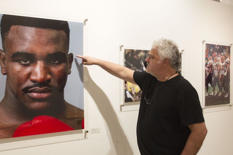 Photographer Scott Cunningham speaks about the process of taking a portrait of boxer Evander Holyfield, at his exhibit in Atlanta. CHAD RHYM / CHAD.RHYM@AJC.COM