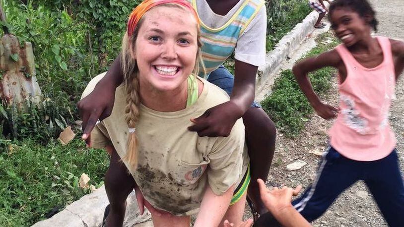 Cassidy Culberson, a Roswell special ed teacher, plays with some children on a recent mission trip to the Dominican Republic. CONTRIBUTED
