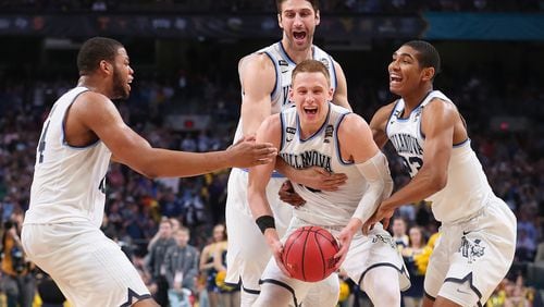 Donte DiVincenzo #10 of the Villanova Wildcats celebrates with teammates after defeating the Michigan Wolverines during the 2018 NCAA Men's Final Four National Championship game at the Alamodome on April 2, 2018 in San Antonio, Texas. Villanova defeated Michigan 79-62.  (Photo by Tom Pennington/Getty Images)