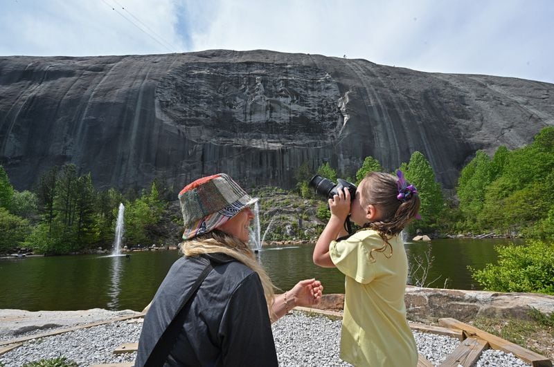 April 20, 2021 Stone Mountain - Pam Topicz watches as her daughter Alayna, 5, takes a picture of Confederate Memorial Carving at Stone Mountain Park on Tuesday, April 20, 2021. Topicz is traveling from Cincinnati, Ohio.  (Hyosub Shin / Hyosub.Shin@ajc.com)