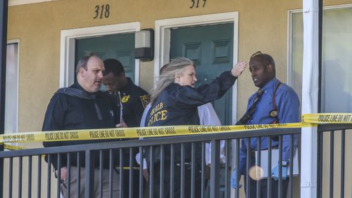 DeKalb County police homicide investigators investigate a death at the United Inn and Suites on Memorial Drive on April 19, 2018. The hotel is among 12 in DeKalb that received a combined 2,397 code enforcement citiations in 2018. JOHN SPINK/JSPINK@AJC.COM