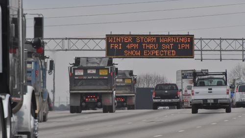 Winter storm warnings flash on the DOT sign on I-85 south of Jimmy Carter Boulevard on Friday, January 6, 2017.