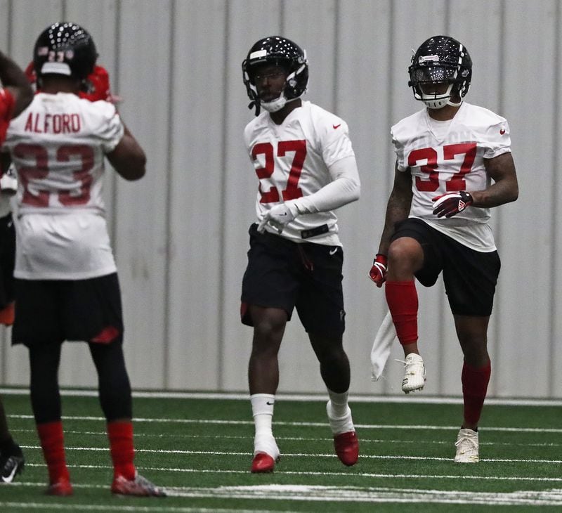Atlanta Falcons safeties Damontae Kazee (cneter) and Ricardo Allen loosen up during organized team activities on Tuesday, May 22, 2018, in Flowery Branch.   