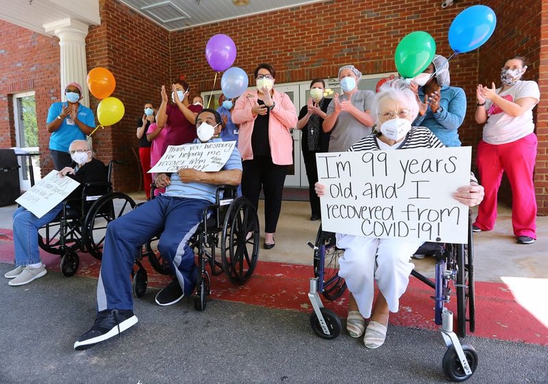 Westbury Medical Care & Rehabilitation staff and a residents have been hit hard by the coronavirus. The staff applauds COVID-19 survivors Sallie Fisher, 96, (from left), Johnny Simmons, 65, and Irma Gooden, 99, while celebrating their recovery. Curtis Compton ccompton@ajc.com