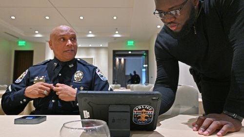 March 24, 2022 Atlanta - Detective Jay Moss (left) and Officer Robinson Desroches, both with Louisville Metro Police, set up a device for their recruiting event at Hyatt Centric Midtown Atlanta on Thursday, March 24, 2022. (Hyosub Shin / Hyosub.Shin@ajc.com)