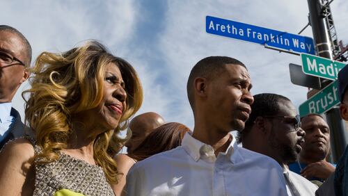 Aretha Franklin and her son Kecalf Cunningham stand under the newly unveiled street sign in front of the Detroit City Music Hall in Detroit, on June 8, 2017.