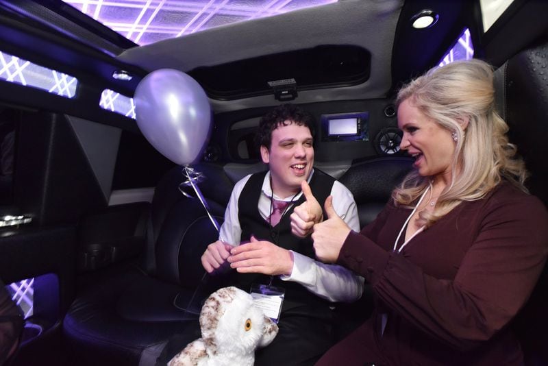 Jason Reynolds smiles as his date, Jennifer Hendricks, gives him a thumbs-up during a limousine ride as a part of the “Night to Shine” event on Feb. 8 at First Baptist Church Atlanta in Dunwoody. The event gives people with disabilities a chance to enjoy a prom night experience. HYOSUB SHIN / HSHIN@AJC.COM