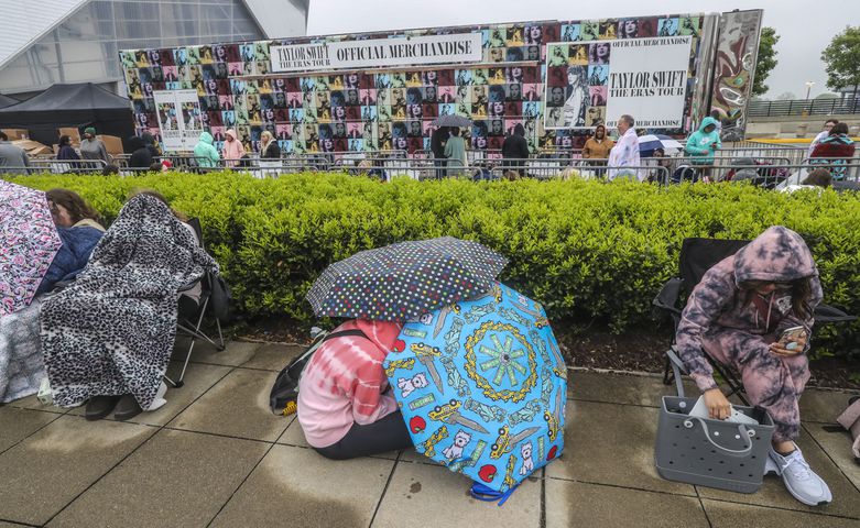 Taylor Swift fans braved cooler morning temperatures and drizzle while they waited in line before daybreak at the Georgia World Congress Center International Plaza outside Mercedes-Benz Stadium to buy official Swift merchandise on Thursday, April 27, 2023. (John Spink / John.Spink@ajc.com)